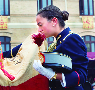 Una dama cadete besa la Bandera con emoción
