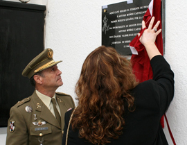 The deceased's widow unveils the commemorative plaque