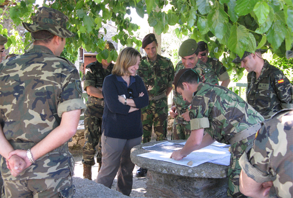 Soldiers from the two countries looking at a map